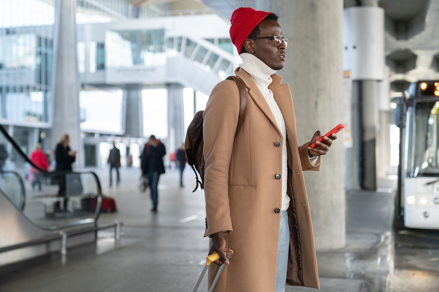 Man with red hat and cell phone.