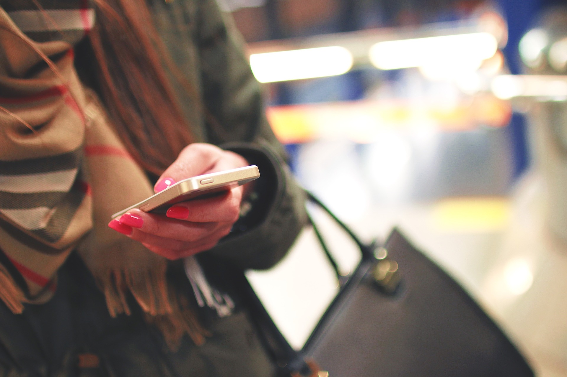 Woman receiving a text while she's shopping.