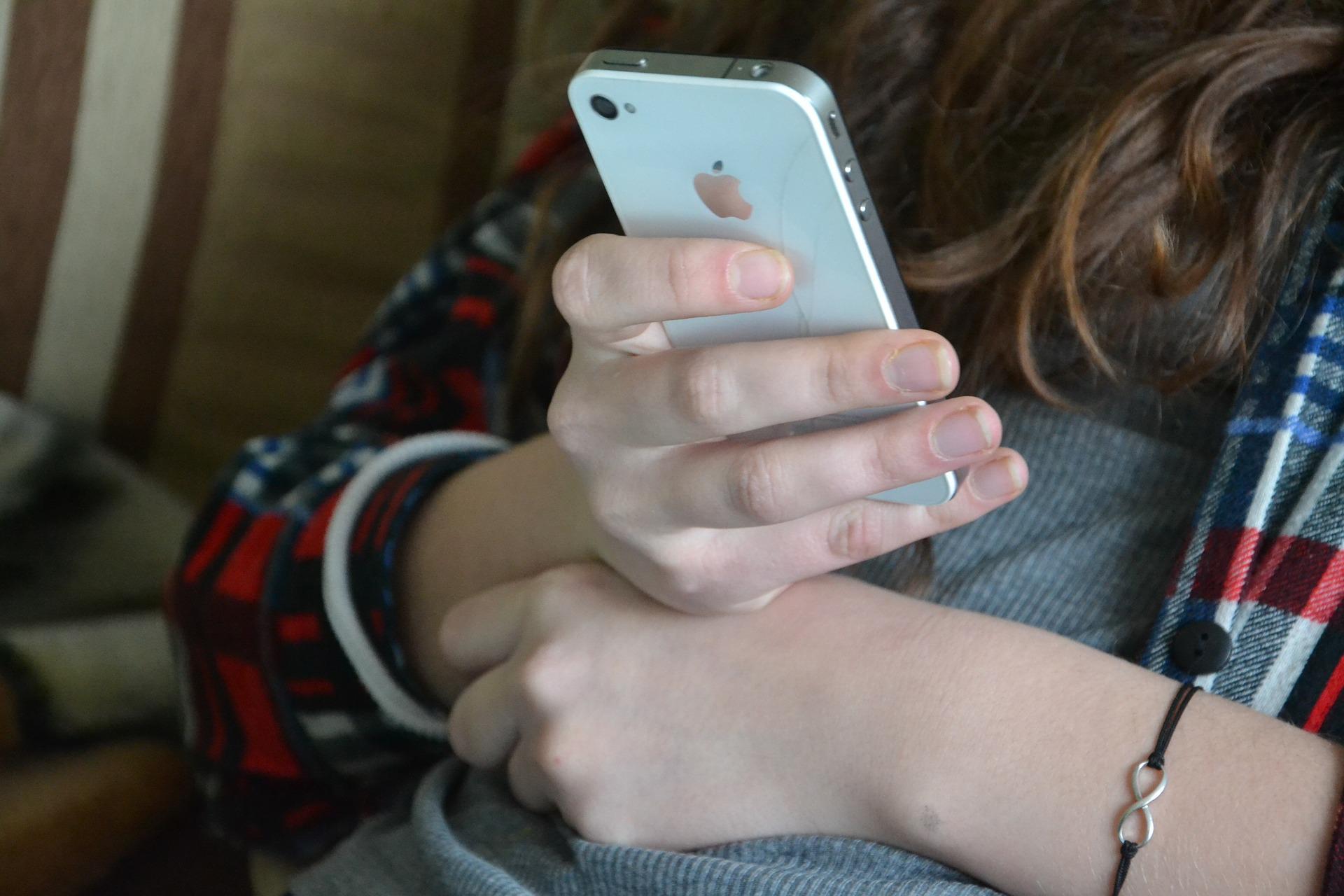 hand holding white iphone