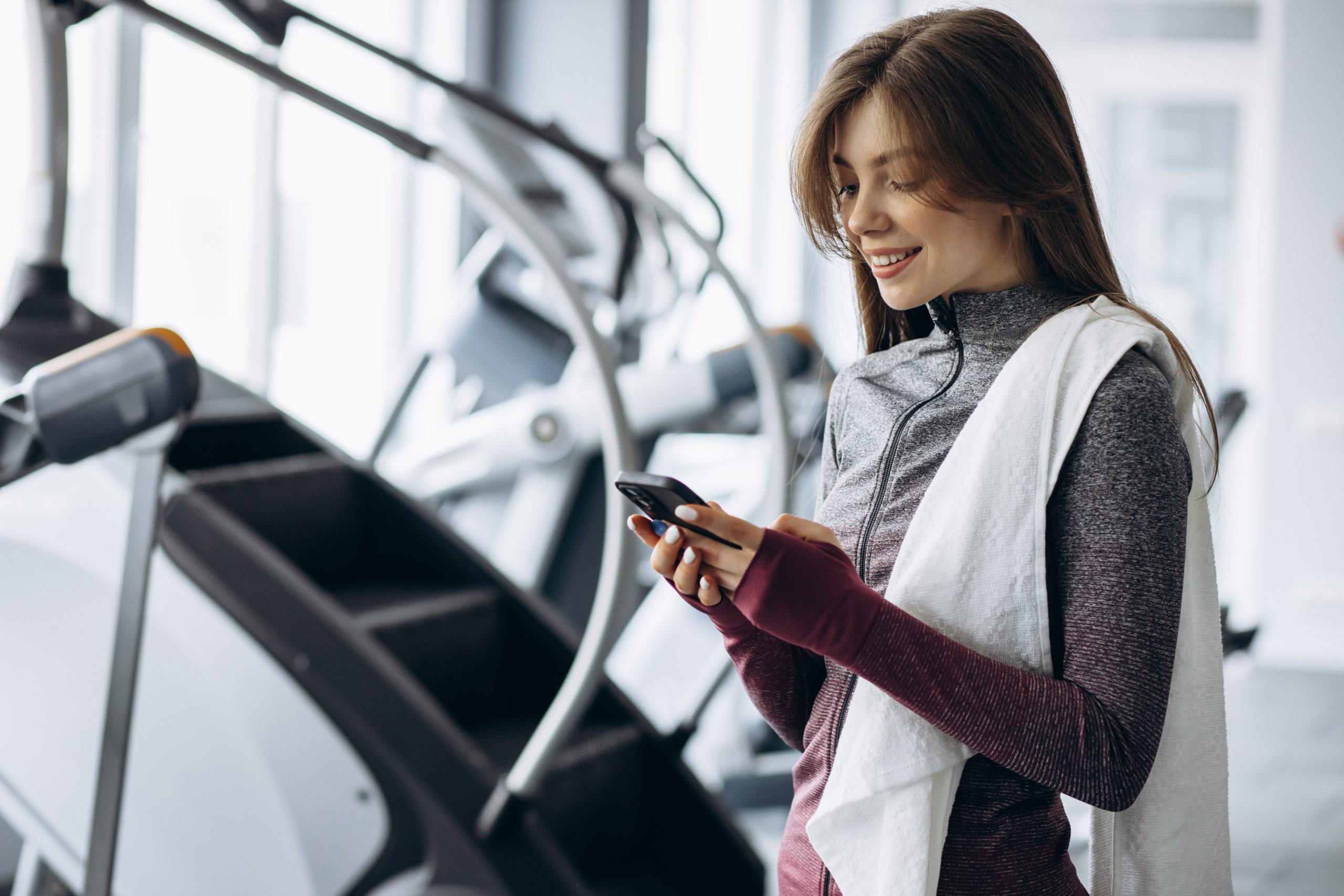 women on phone in the gym